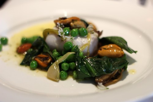 Poached fillet of hake, wild garlic, peas, shallot and mussel butter