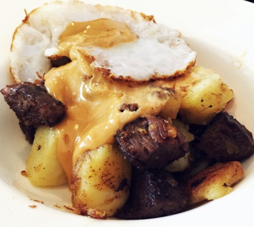 Crispy potato hash with fried duck egg and Braised beef, HP hollandaise, crispy shallots