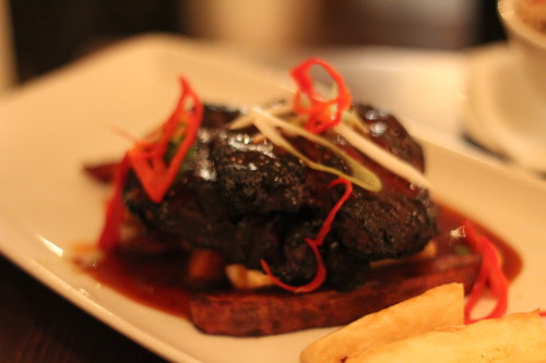 Marinated grilled chunks of pork smothered with jerk barbecue sauce served on a bed of root vegetable trio, rice n peas
