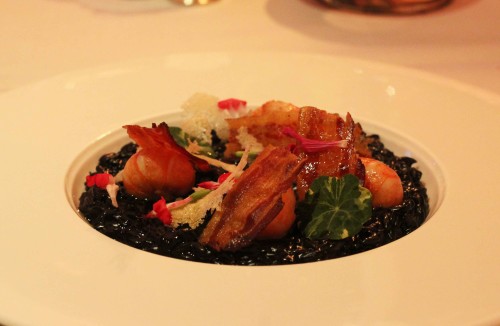 Poached Langoustine, squid ink orzo pasta, black garlic crispy pancetta and wilted sea herbs
