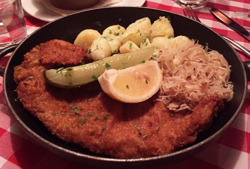 Bodo’s Veal Wiener Schnitzel Served with Sauerkraut traditional Austrian potato salad pickle and lemon